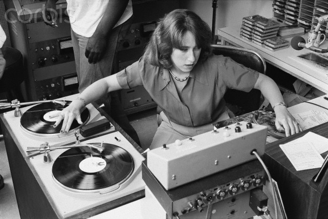 13 Jul 1978 --- KRE radio disc jockey Joanne Rosenweig spins a record on her broadcast. --- Image by © Roger Ressmeyer/CORBIS